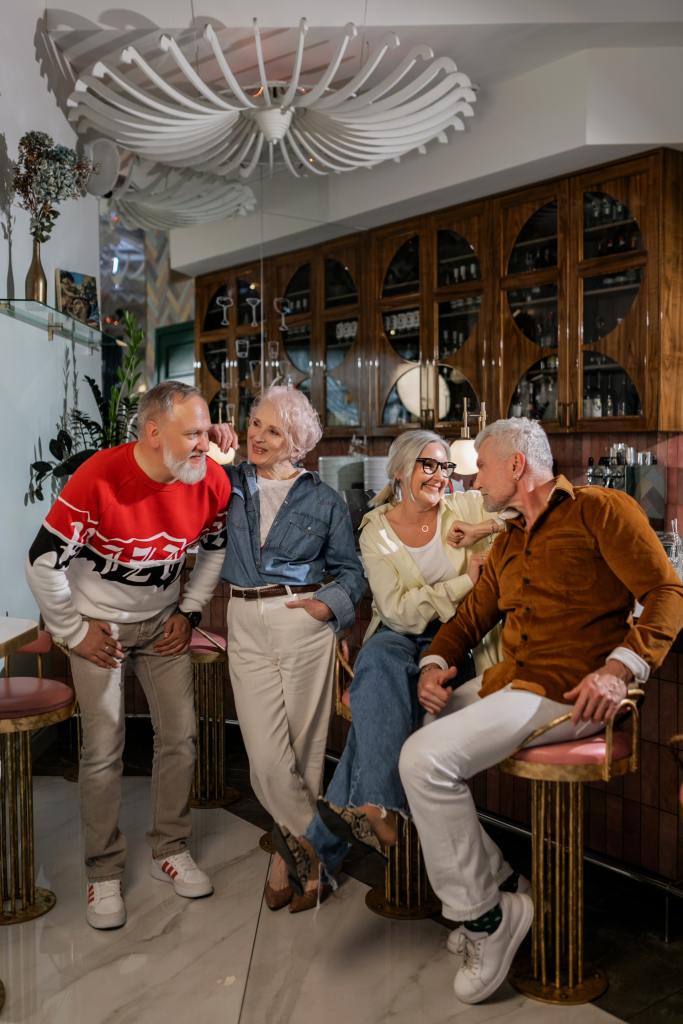 Two older couples sit together at a bar
