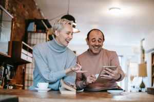 Older couple looking at a tablet and laughing
