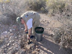 Toby Younis digging in an arroyo