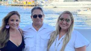 Erica English, Toby Younis and Toby Renee Younis in front of boats