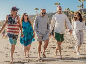 Group of adults walk on the beach together